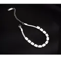 Detail of silver snake chain bracelet with polished beads and lobster clasp on black background - Silver