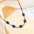 Detailed view of a gold blade chain necklace with five smooth oval blue gemstones - Blue Necklace