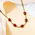 Golden snake chain necklace featuring five oval red gemstones in a vintage aesthetic - Dark Red Necklace