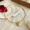 Polished gold heart pendant on a sleek snake chain necklace for women's jewelry - Heart / Gold