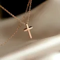 Minimalist rose gold cross pendant necklace on cream silk background for women - Rose Gold