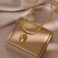 Elegant gold titanium necklace with hollow leaf pendant and white shell inlay on silk - Leaf Necklace