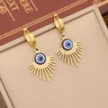Gold Evil Eye hoop earrings with blue enamel center and radiant fringe tassels - Dangle Earrings