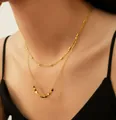 Close-up of double-layered gold beaded necklace on a model wearing a black dress - Double Layer Cube Style / Gold