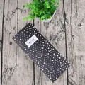 Detail view of black drawer gift box with white polka dots and merci beaucoup label - Black Snowflake