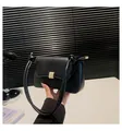 Elegant black leather baguette bag with a gold square lock and knotted rope shoulder strap - Black