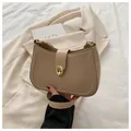 Gros plan sur la boucle dorée et la texture en cuir mat kaki du sac demi-lune - Kaki