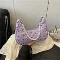 Lavender pleated underarm bag with black bow prints and elegant pearl handle strap - Purple