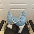 Light blue hobo bag with bow print and white faux pearl handle for trendy summer style - Blue