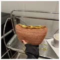 Detailed texture of brown straw woven bag with unique gold metallic handle and chain - Brown