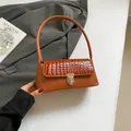 Brown faux crocodile skin underarm bag with gold metal clasp and minimalist handle - Brown