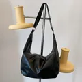 Minimalist black faux leather hobo bag with wide shoulder strap in crescent design - Black