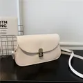 Minimalist cream white saddle bag with golden metal lock and slim leather shoulder strap - Off White