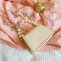 Minimalist beige mini crossbody bag with pearl and silver heart chain handle decoration - Off White