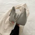Chic gray crescent-shaped PU leather handbag with zipper closure and metal buckle detail - Gray