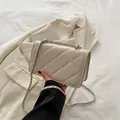 Chic beige quilted crossbody bag featuring a classic silver-tone chain leather strap - White