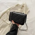Classic black quilted shoulder bag with silver chain strap and rhombus stitch pattern - Black