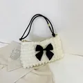 Chic bubble texture shoulder bag in beige with a large black bow and dual straps - White