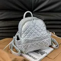 Silver quilted mini backpack with metallic finish and cute bow detail on dark leather - Silver