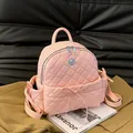 Pink quilted leather backpack for women featuring a bow tie and silver zippers - Pink