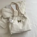 Creamy white velvet butterfly tote bag with plush charm and polished texture - With Ornament / White