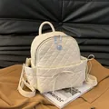 Beige quilted leather backpack for women featuring a bow and lion relief emblem - Off-white