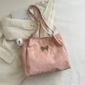 Pink pleated velvet tote bag featuring a golden butterfly buckle and plush pompom charm - With Ornament / Pink