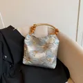 Light blue floral tapestry shoulder bag with decorative wooden bead handle and vintage style - Blue