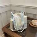 Light blue jacquard canvas bag with gold oriental embroidery and tassel detail - Blue