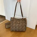 Chic leopard print tote bag with brown leather straps and fashion label detail - Brown