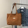 Stylish brown corduroy tote bag with large pocket and long shoulder straps for daily use - Tan
