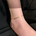 Detail of 18K gold-plated flat snake chain anklet showing adjustable lobster clasp - Herringbone Chain Anklet (J724) / Gold