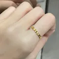 Minimalist gold-plated stainless steel heart pattern band ring shown on model hand - US Size 10 / Heart Engraved Gold