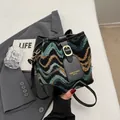 Chic bucket bag in green and black wavy woven pattern with premium black leather trim - Black