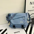 Light blue crossbody messenger bag with waterproof fabric and white rope accents - Blue