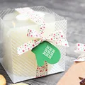 White pillar candle in transparent textured gift box with festive ribbon and glove tag - Multicolor Star / 10mm x 23m