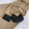 Women's two-piece crossbody bucket bag in black and beige contrast leather with gold trim - Black (2-Piece Set)