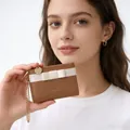Detailed view of brown leather wallet with white bow and golden chain strap - Khaki