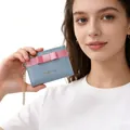 Detail of macaron blue women's mini wallet featuring pink bow and gold chain strap - Grey Blue