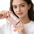 Detail of pink PU leather wallet featuring white ribbon bow and gold Classic Star logo - Light Pink
