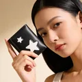 Detail of black leather wallet showing white star patch decor and fine sewing texture - Black