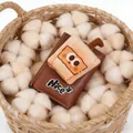 Detail of a brown leather wallet featuring a 3D plush milk tea patch and Nice embroidery - Cute Milk Tea Character