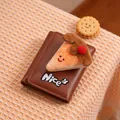 Close-up of brown leather wallet with plush cake decor and Nice embroidery detail - Chocolate Cake Character