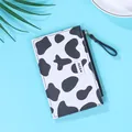 Slim women's wallet featuring black and white cow print with a milk label and side zipper - Black Cow Print
