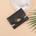 Minimalist black tri-fold wallet for women featuring glitter panels and golden turnlock - Black