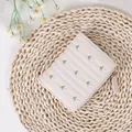 Compact cream leather wallet for women with delicate floral embroidery and zipper - White