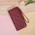 Elegant long quilted wallet for women in burgundy red with secure zipper and wrist strap - Red