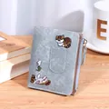 Slim light blue embroidered cat wallet with gold zipper on a rustic wooden desk - Light Blue