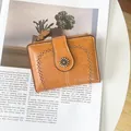Detail view of retro brown faux leather wallet with metallic sunflower and hollow pattern - Antique Yellow