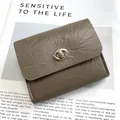 Taupe crackle pattern leather wallet with silver metal clasp on minimalist magazine - Gray